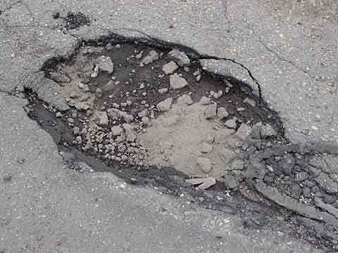 How do the potholes appear on the road