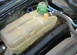 Where should the car's coolant level be when cold